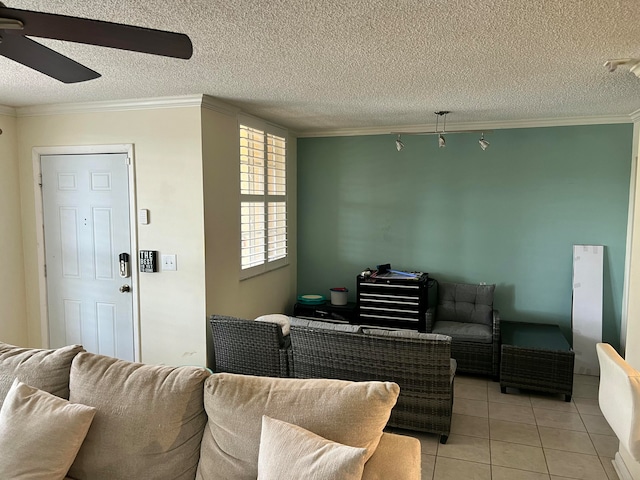 living room featuring crown molding, light tile patterned floors, and a textured ceiling