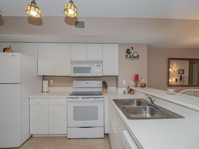 kitchen with white appliances, visible vents, white cabinets, light countertops, and a sink