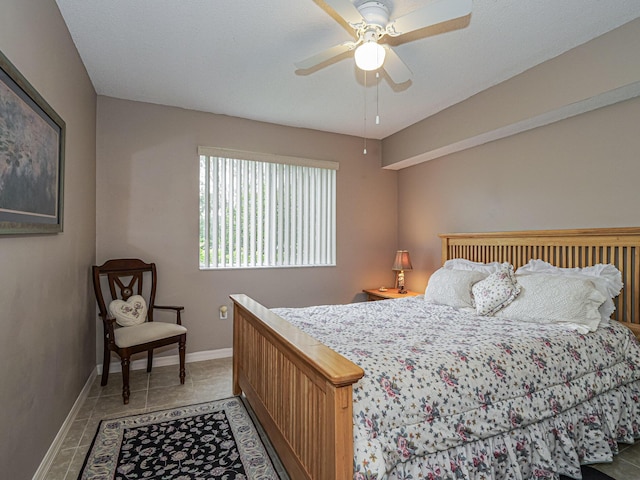 bedroom featuring ceiling fan, tile patterned flooring, and baseboards