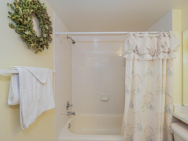 bathroom with toilet and shower / bath combo