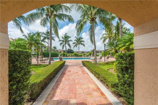 view of property's community with a pool and a patio area