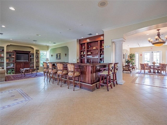 bar with a wealth of natural light, tile patterned floors, decorative columns, and recessed lighting