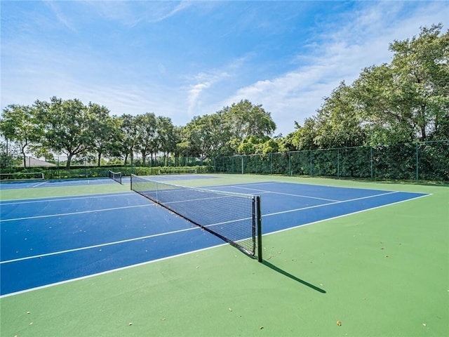 view of sport court featuring fence