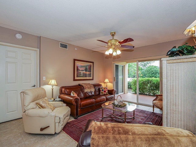 living room with light tile patterned flooring, visible vents, and a ceiling fan