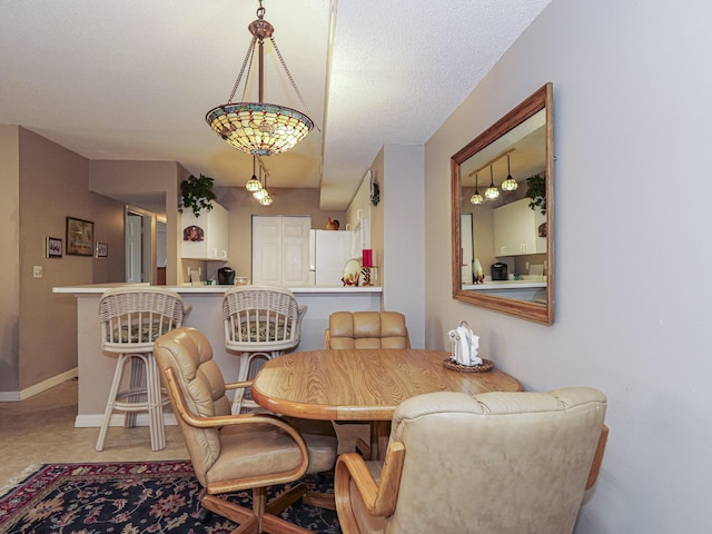 dining space featuring baseboards