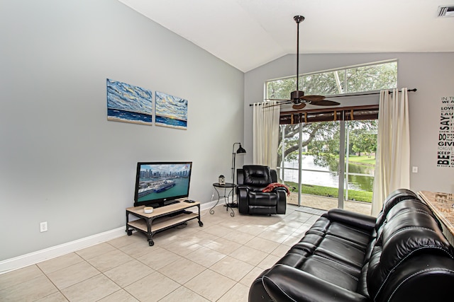 living room with ceiling fan, light tile patterned floors, and vaulted ceiling