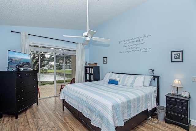 bedroom with access to exterior, a textured ceiling, vaulted ceiling, ceiling fan, and wood-type flooring