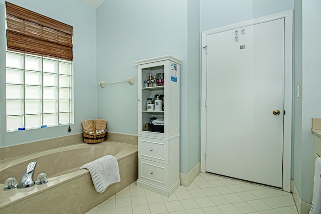 bathroom with tile patterned flooring and a washtub