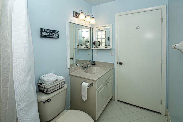 bathroom with tile patterned floors, vanity, and toilet