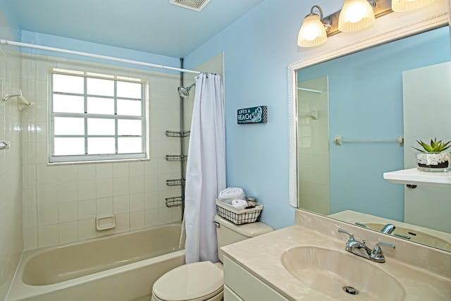 full bathroom with shower / bath combination with curtain, vanity, and toilet