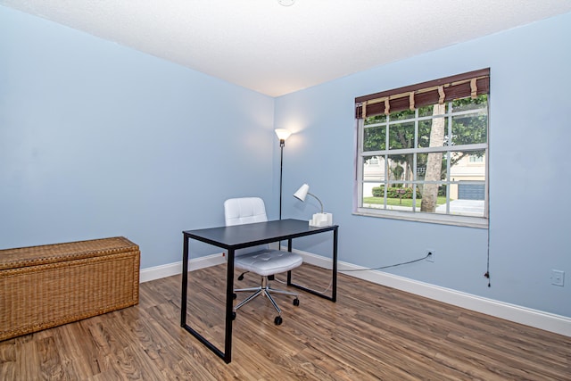 office featuring a textured ceiling and hardwood / wood-style flooring