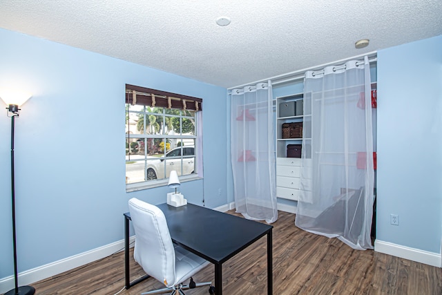 home office with hardwood / wood-style floors and a textured ceiling