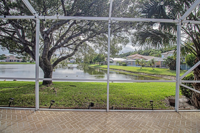 unfurnished sunroom with a water view