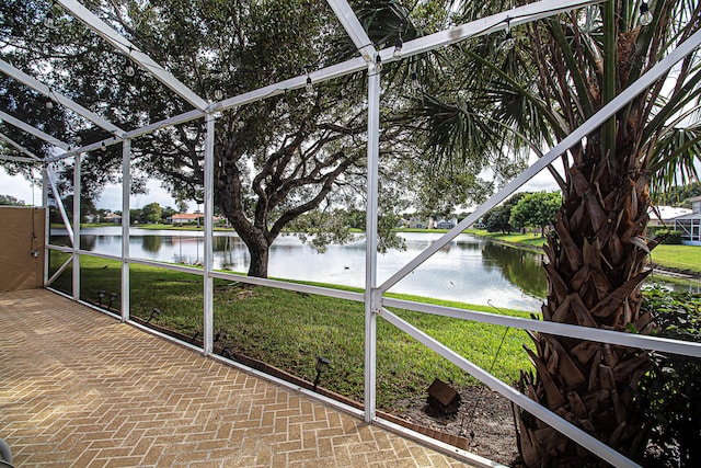 unfurnished sunroom with a water view