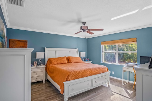 bedroom featuring hardwood / wood-style floors, a textured ceiling, ceiling fan, and crown molding