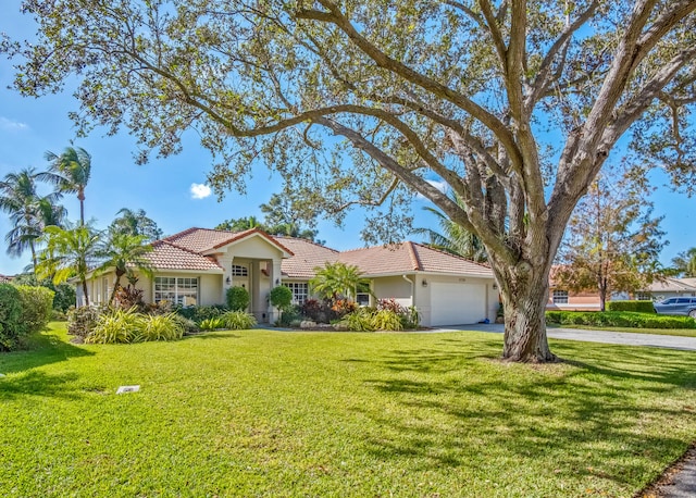 view of front facade featuring a front yard and a garage