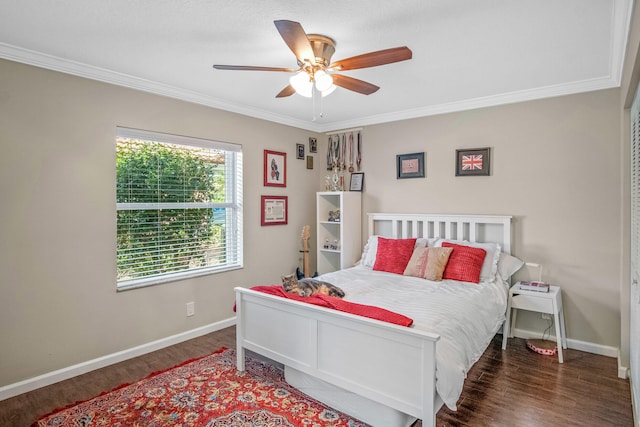 bedroom with dark hardwood / wood-style floors, ceiling fan, and crown molding