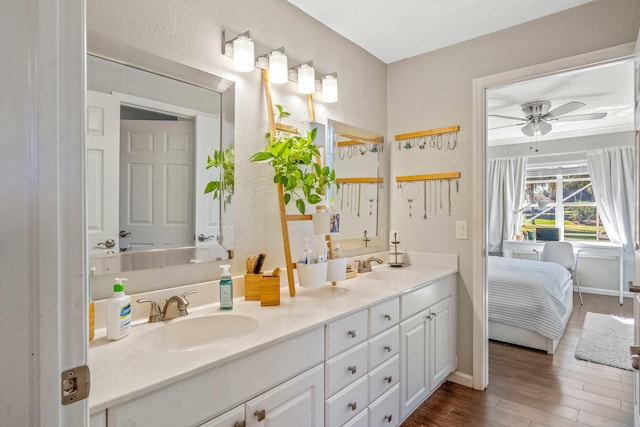 bathroom featuring vanity, hardwood / wood-style flooring, and ceiling fan