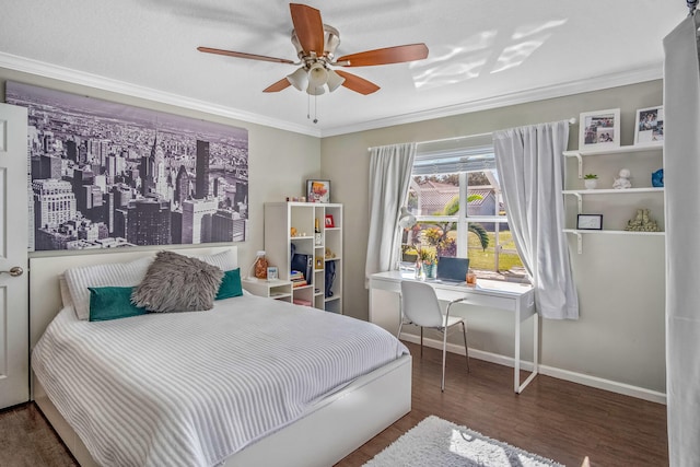 bedroom with ceiling fan, built in desk, dark wood-type flooring, and ornamental molding