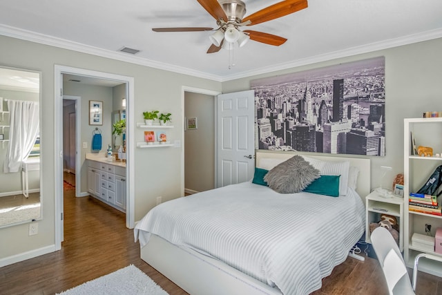 bedroom featuring ensuite bath, ceiling fan, dark wood-type flooring, and crown molding