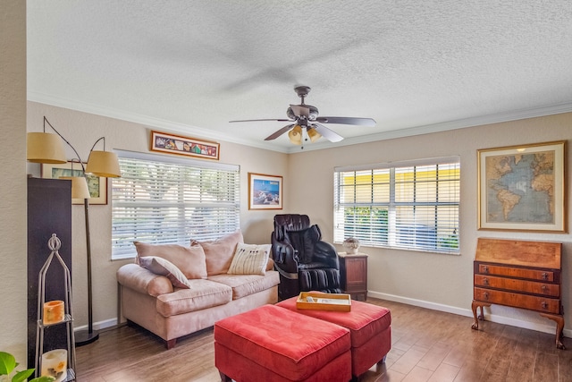 living room with crown molding, ceiling fan, a healthy amount of sunlight, and hardwood / wood-style flooring