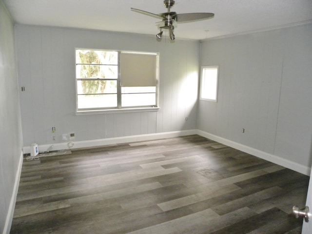 empty room featuring ceiling fan, plenty of natural light, and hardwood / wood-style flooring