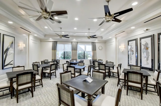 dining space featuring a tray ceiling, ceiling fan, and ornamental molding