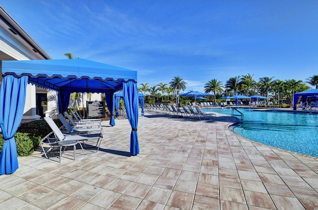 view of swimming pool with a gazebo and a patio area