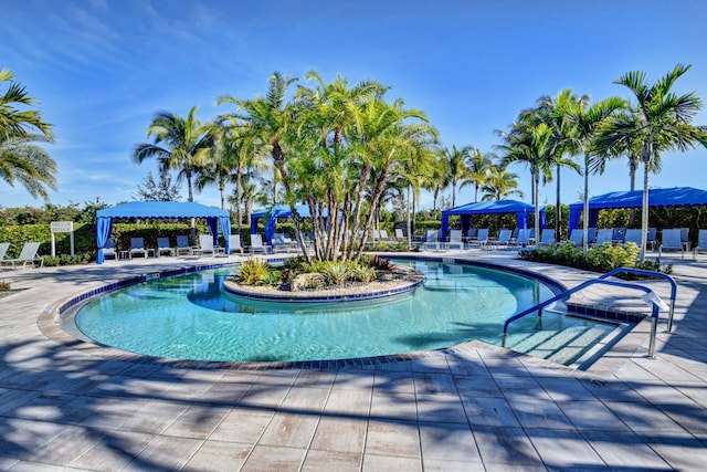 view of swimming pool featuring a mountain view, a gazebo, and a patio area