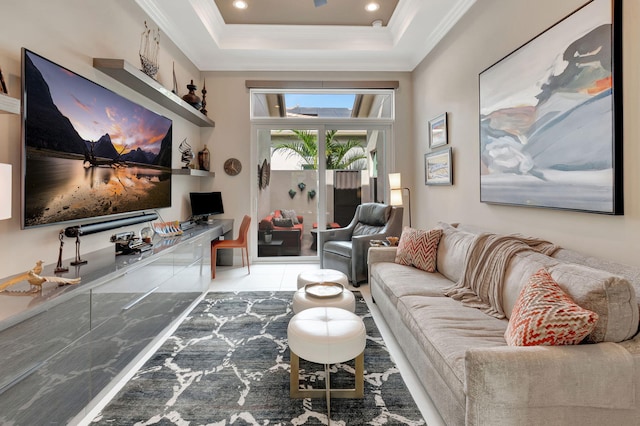 living room with a raised ceiling and ornamental molding