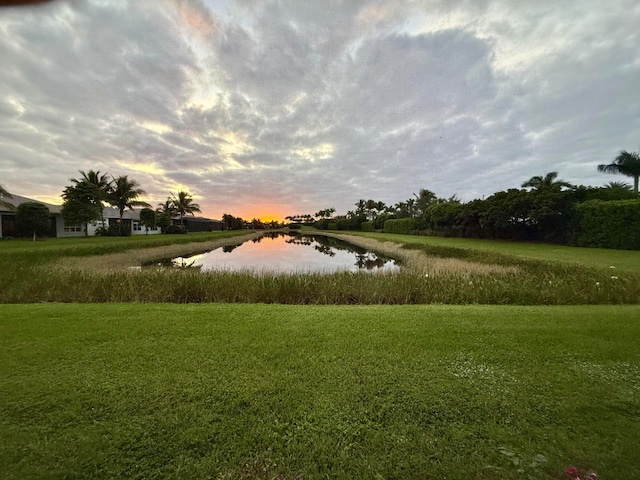 view of community with a yard and a water view