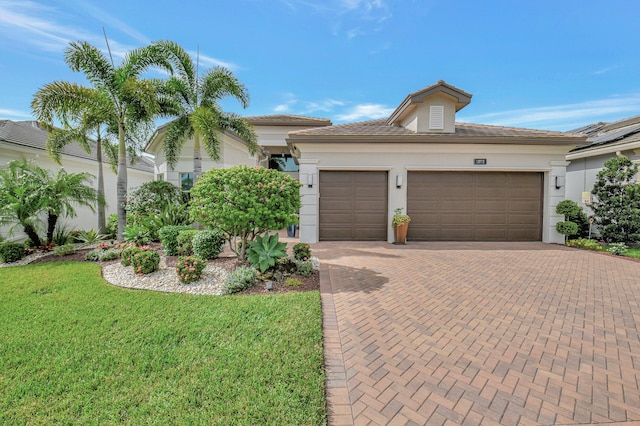 view of front of property with a garage and a front yard