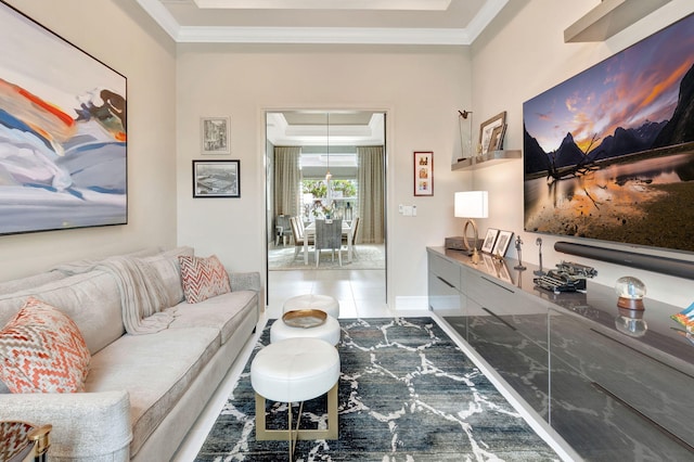 living room with a raised ceiling and crown molding