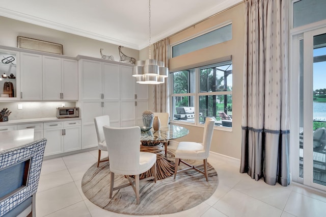 tiled dining room featuring ornamental molding