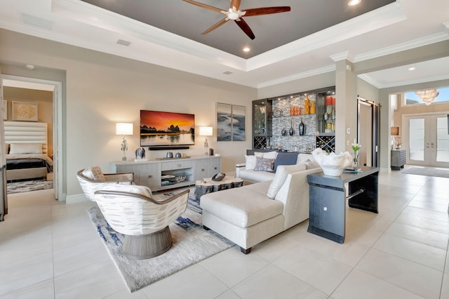 living room featuring french doors, a tray ceiling, light tile patterned floors, and crown molding