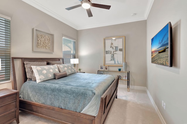 carpeted bedroom featuring ceiling fan and crown molding