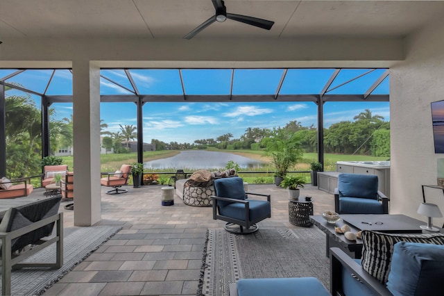 view of patio / terrace with an outdoor hangout area, glass enclosure, and ceiling fan