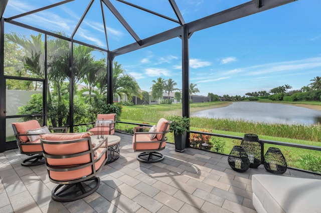 exterior space with glass enclosure and a water view