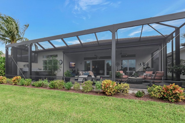 back of house with outdoor lounge area, ceiling fan, a yard, a lanai, and a patio area