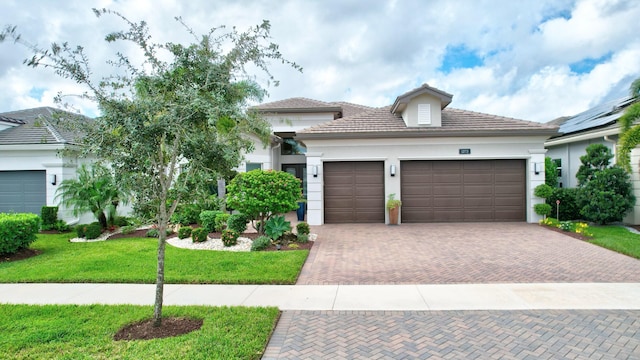 view of front of house featuring a front yard and a garage