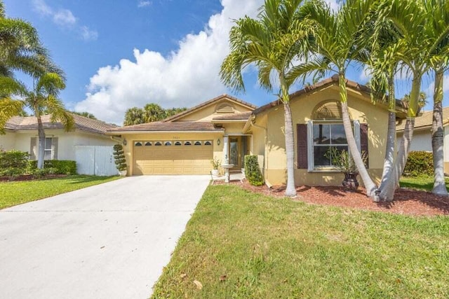 mediterranean / spanish-style house with a garage and a front yard