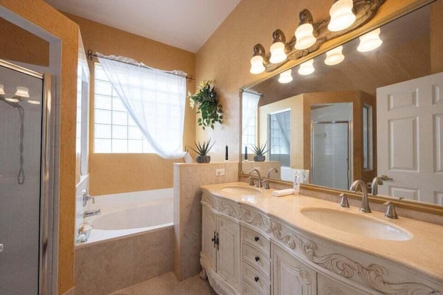 bathroom featuring vanity and shower with separate bathtub