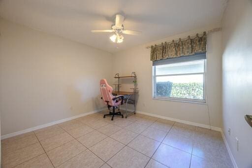 unfurnished room featuring light tile patterned floors and ceiling fan