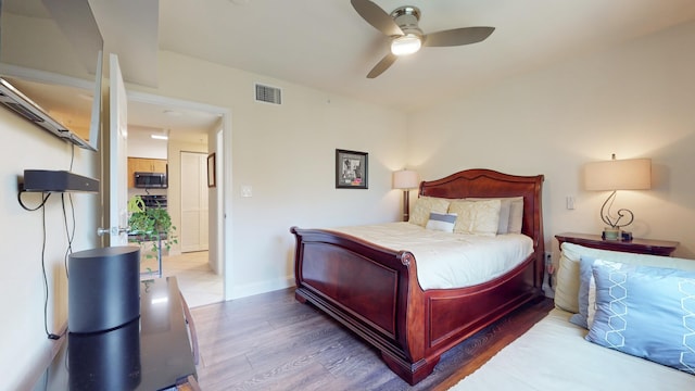 bedroom featuring ceiling fan and light hardwood / wood-style flooring