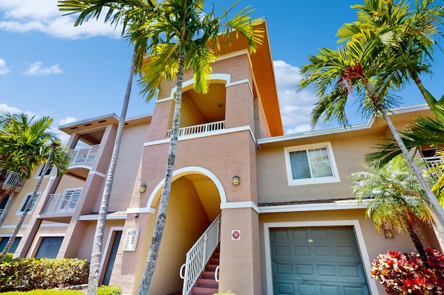 view of front of house featuring a balcony and a garage