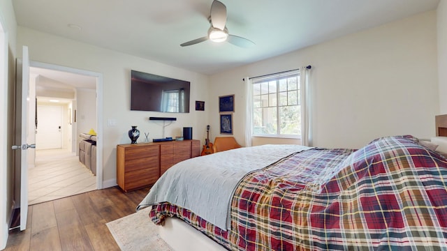 bedroom with ceiling fan and wood-type flooring