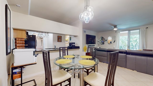 tiled dining room with ceiling fan with notable chandelier