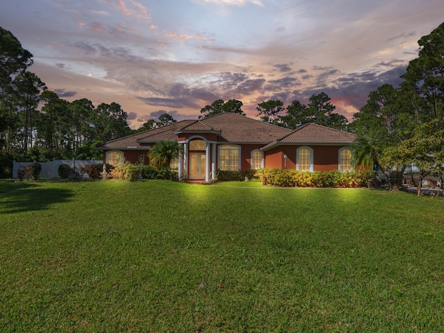 mediterranean / spanish-style house featuring a lawn