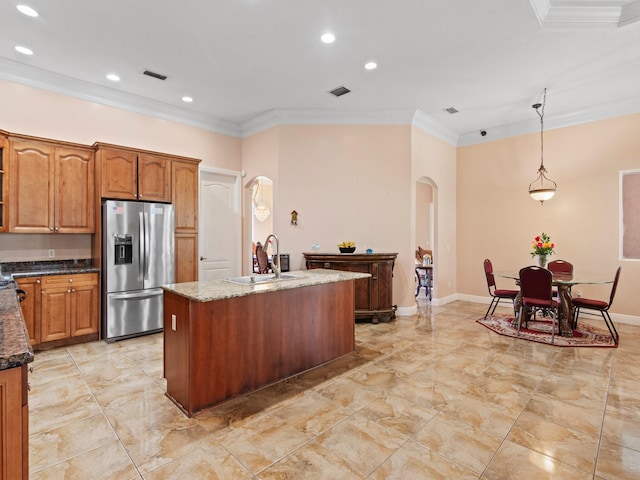 kitchen featuring sink, decorative light fixtures, stainless steel refrigerator with ice dispenser, and ornamental molding