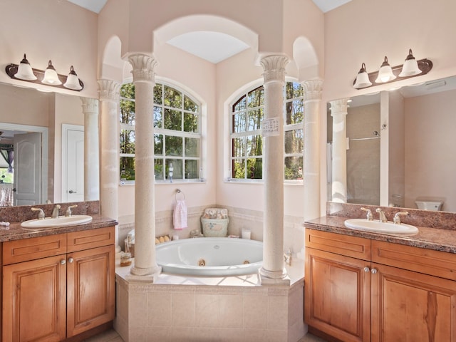 full bathroom with toilet, vanity, decorative columns, and separate shower and tub